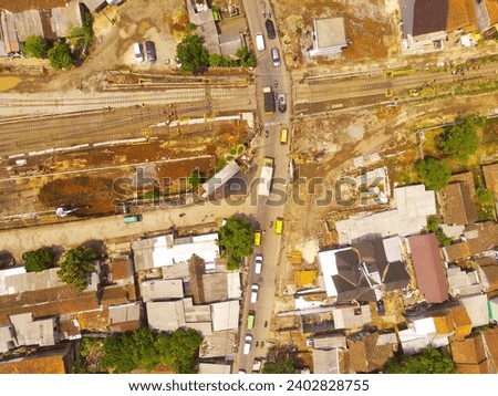 Industrial Photography Landscapes. Aerial view of the intersection of railway tracks and public roads, Located in Cicalengka, Bandung - Indonesia. Aerial Shot from a flying drone.