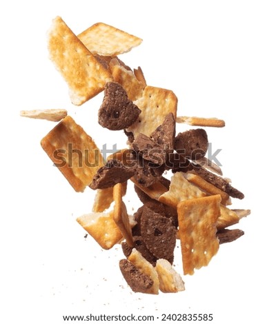 Mixed Cracker Butter Cookie Chocolate chip fall fly in mid air, cookie cracker floating. Mixed Cracker Butter Cookie Chocolate chip crack crunch throw in air. White background isolated freeze motion