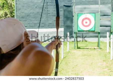 practicing the sport of archery training good aim outdoors to hit the target Royalty-Free Stock Photo #2402837503