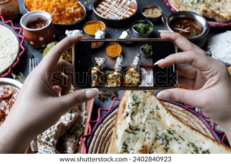 Hands of a blogger taking a photo of food with a smartphone