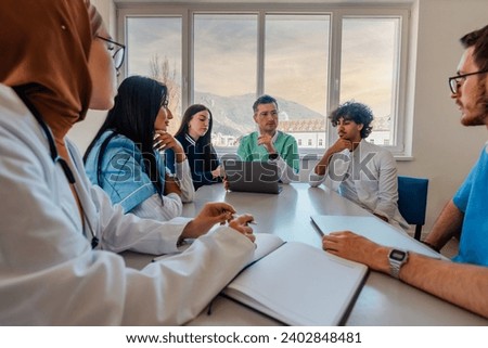 A medical team of doctors discussing and planning a work strategy at a meeting in the conference room.