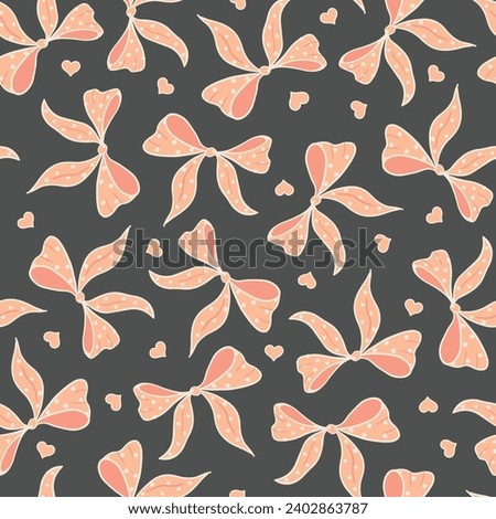 Seamless vector pattern with peach colored feminine bows and hearts on charcoal grey. Textile