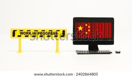 A picture of screen monitor with China flag in barcode and work in progress sign. Made In China 2025 project.