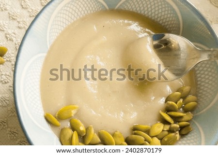 Akamu, Pap, Ogi or Corn Porridge – thick, creamy, and silky smooth breakfast porridge made from fresh corn Royalty-Free Stock Photo #2402870179