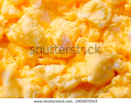 Texture of tasty scrambled eggs as background
