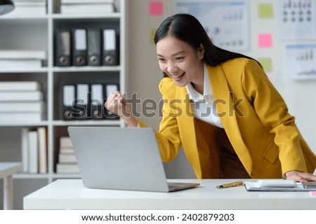 Cheerful businesswoman working with laptop in office, chatting Look at the laptop and talk about business, marketing, presentations video conference call meeting online training working in the office