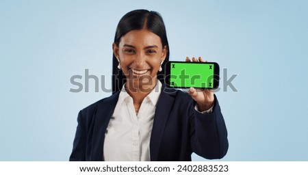 Happy business woman, phone and green screen for advertising against a blue studio background. Portrait of female person or employee smile showing mobile smartphone display, chromakey or mockup space