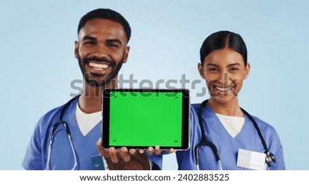 Doctor, portrait and tablet with green screen for healthcare advertising against a blue studio background. Man and woman, nurse or medical team showing technology display, chromakey or mockup space