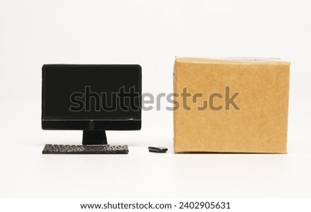 A picture of toy computer with empty box. Online shopping and business concept.