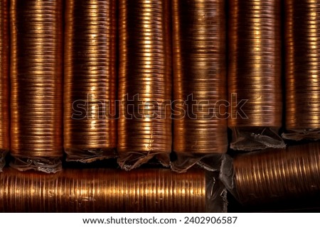 Showing a background of several one cent coin rolls. 