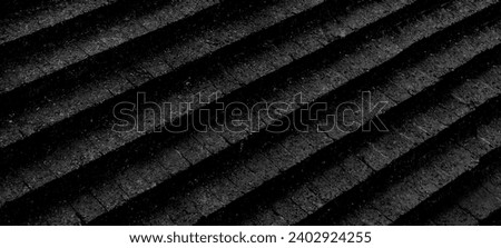 Abstract black background with diagonal lines. Black abstract geometric background. wall texture. Abstract stairs in black and white, abstract roof.
