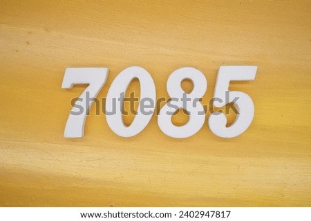 The golden yellow painted wood panel for the background, number 7085, is made from white painted wood.