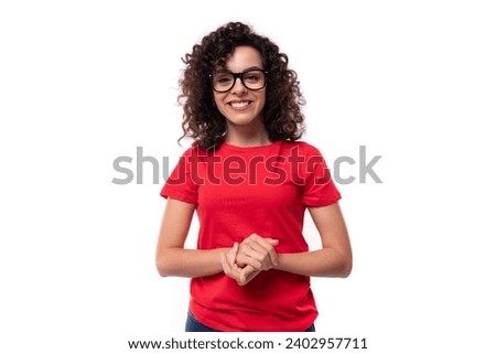 close-up of a caucasian young pretty curly brunette woman in a red t-shirt Royalty-Free Stock Photo #2402957711