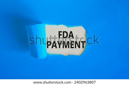 FDA Food and Drug Administration payment symbol. Concept words FDA payment on beautiful white paper. Beautiful blue paper background. Business FDA payment concept. Copy space.