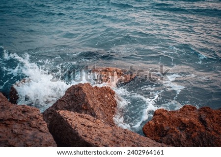 Seaside near Barcelona close up concept photo. Water with stones on the beach. Underwater rock. The view from the top, nautical background. High quality picture for wallpaper
