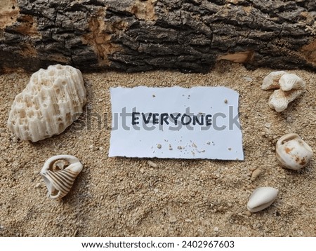 The writing everyone on the beach sand background.