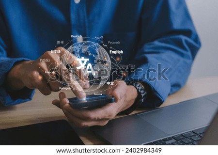 Man hand holding a smartphone to Translation of foreign languages on mobile app.Symbol of translation.Ai translator.Mobile app worldwide language conversation. Royalty-Free Stock Photo #2402984349