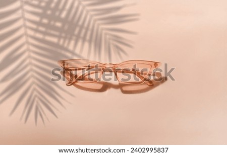 Summer sunglasses on a pink background. New trending PANTONE Peach Fuzz colour of 2024 year