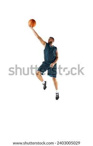 Powerful moment frozen in time, professional basketball player commitment to perfect slam dunk against white studio background. Concept of sport, hobby, active lifestyle, power, strength. Copy space
