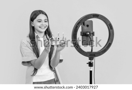 cheerful teen blogger girl with crown on background. photo of teen blogger girl with crown.