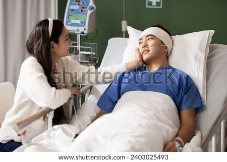 The man looks at his wife, appreciating her presence during his recovery.