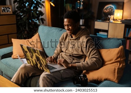 Happy delighted attractive young guy freelance writer, crafting articles blog posts for clients all around the world working on new piece of content.