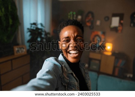 Cheerful young dark skinned afro american teenager woman having fun smiling laughing ready to go out relaxation concept at home. Woman wearing casual clothes.
