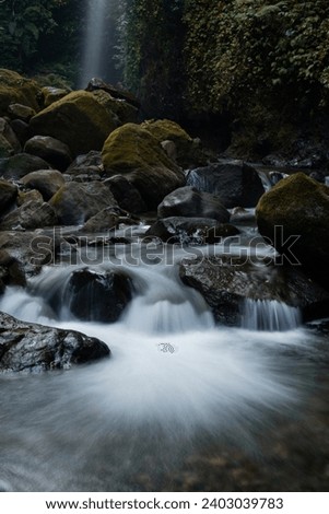 The river gracefully meandering through three stone crevices, creating a stunning natural spectacle. Captured on Sunday, December 17, 2023.  Royalty-Free Stock Photo #2403039783