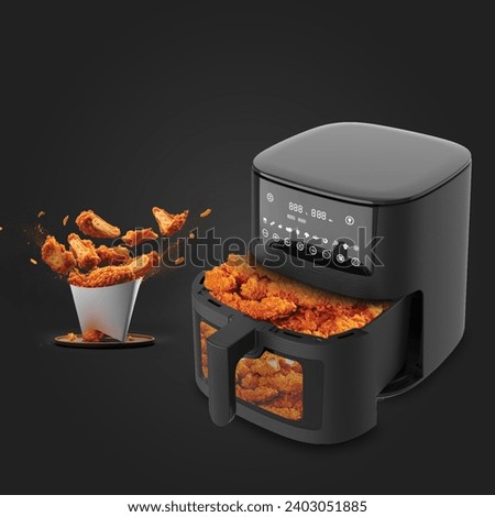 Air fryer for frying chicken and potatoes in a healthy way, black color, distinctive background Royalty-Free Stock Photo #2403051885