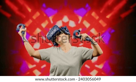 The beautiful woman moves activity in modern virtual reality dance game.Led screen with blur background.The woman wearing VR headset dancing in virtual reality. Concept high technology digital device