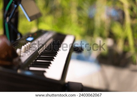 Side view of black and white keys on an electronic piano ,background dissolves.