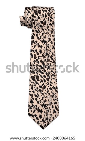 Closeup of an elegant stylish tie with cheetah pattern rolled and isolated on a white background