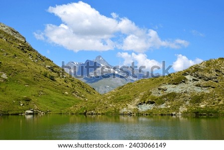 Mountain lake Lago di Loie in National park Gran Paradiso, Lillaz, Cogne, Aosta valley, Italy. Summer landscape in the Alps. Royalty-Free Stock Photo #2403066149