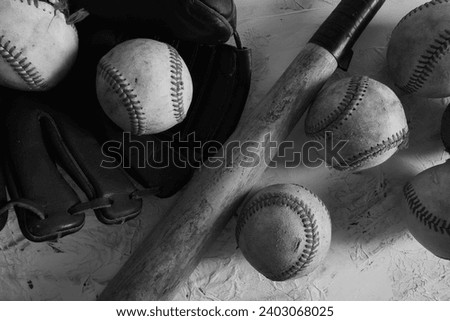 Baseball equipment flat lay with aged balls and glove as sports background art in black and white. Royalty-Free Stock Photo #2403068025