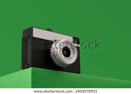 Vintage camera on a green background. Copy space for text.