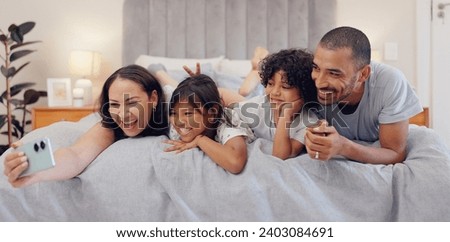 Selfie, smile and children with parents in bed relaxing and bonding together at family home. Happy, fun and young mother and father laying and taking a picture with kids in bedroom of modern house.