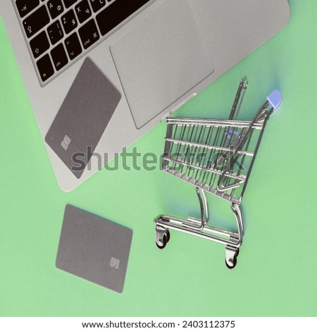 The picture shows an open laptop with a credit card next to it for online shopping 