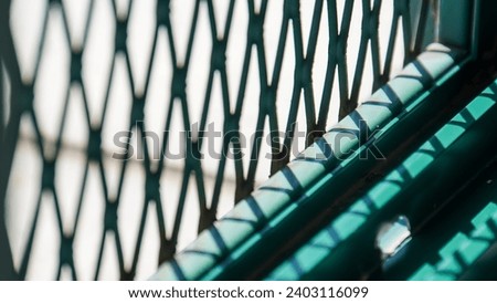 green window grille with shadow