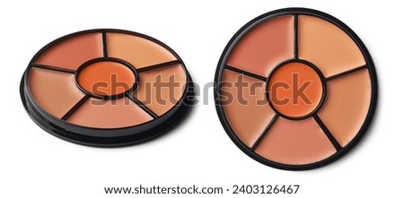 round shaped concealer palette, compact and sleek design contain a range of concealer shades for skin concerns like blemishes, dark circles and redness, isolated on white background Royalty-Free Stock Photo #2403126467
