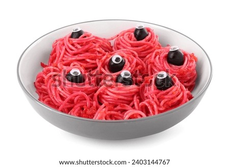 Red pasta with decorative eyes and olives in bowl isolated on white. Halloween food
