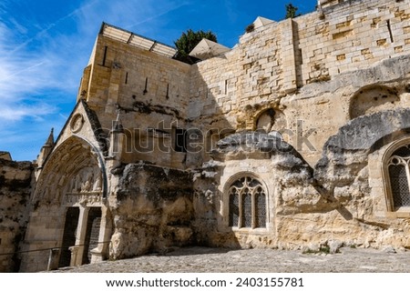 Views of old houses and narrow hilly streets of medieval town St. Emilion, production of red Bordeaux wine on cru class vineyards in Saint-Emilion wine making region, France, Bordeaux Royalty-Free Stock Photo #2403155781