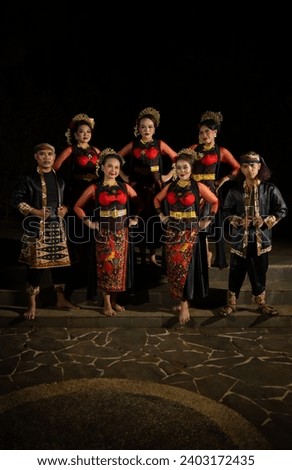 a group of dancers standing very proud and happy after finishing performing on stage at night Royalty-Free Stock Photo #2403172435