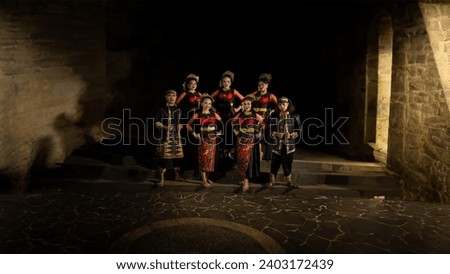 a group of dancers standing very proud and happy after finishing performing on stage at night Royalty-Free Stock Photo #2403172439