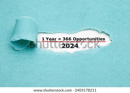 Motivational quote 1 Leap Year 2024 equal to 366 opportunities seen through a hole in ripped blue paper. Royalty-Free Stock Photo #2403178211