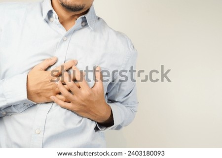 the man pressed his chest with a painful expression. Severe heartache, having a heart attack or painful cramps, heart disease