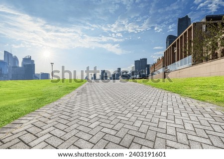 Brick road and city buildings in the park in Shanghai