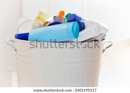 Plastic waste in a white garbage can in a throwaway society causing microplastics Royalty-Free Stock Photo #2403199217
