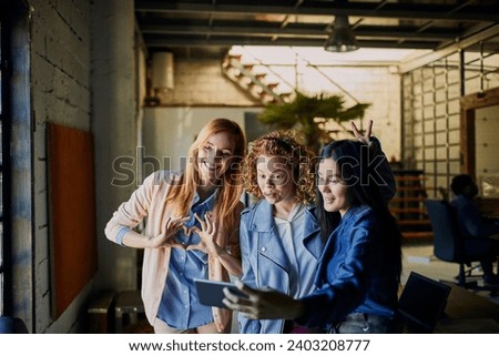 Young business women taking selfie in the office Royalty-Free Stock Photo #2403208777