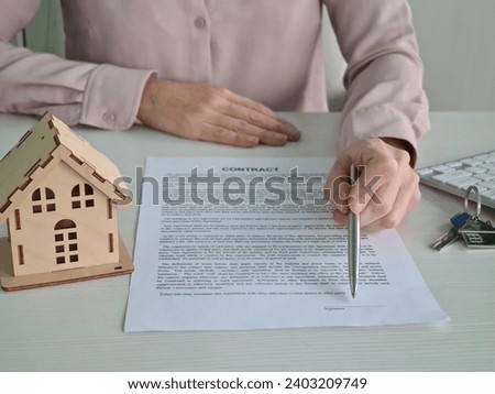 Real estate agent and client sign a contract to buy house. Real estate insurance or loan