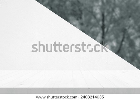 White Wooden Table with Concrete Wall and Blurred Garden Background, Suitable for Product Presentation Backdrop, Display, and Mock up.